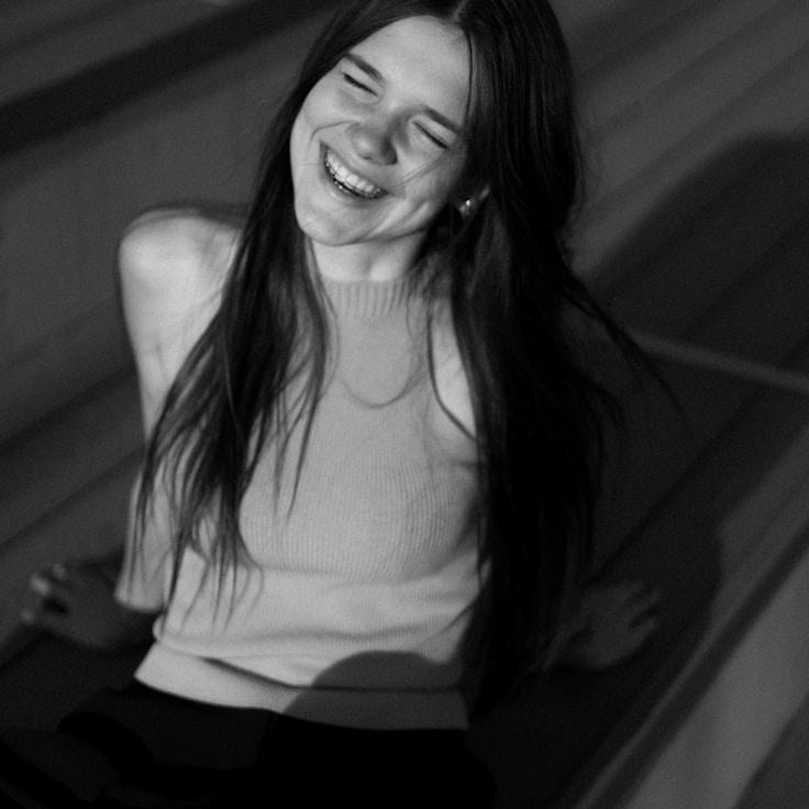 Avery Chen, Lead Design Curator at LagoonPetalCrest, reviewing corporate floral arrangements